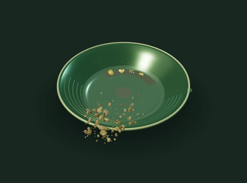A worn gold pan with water, dark river sand and glints of gold